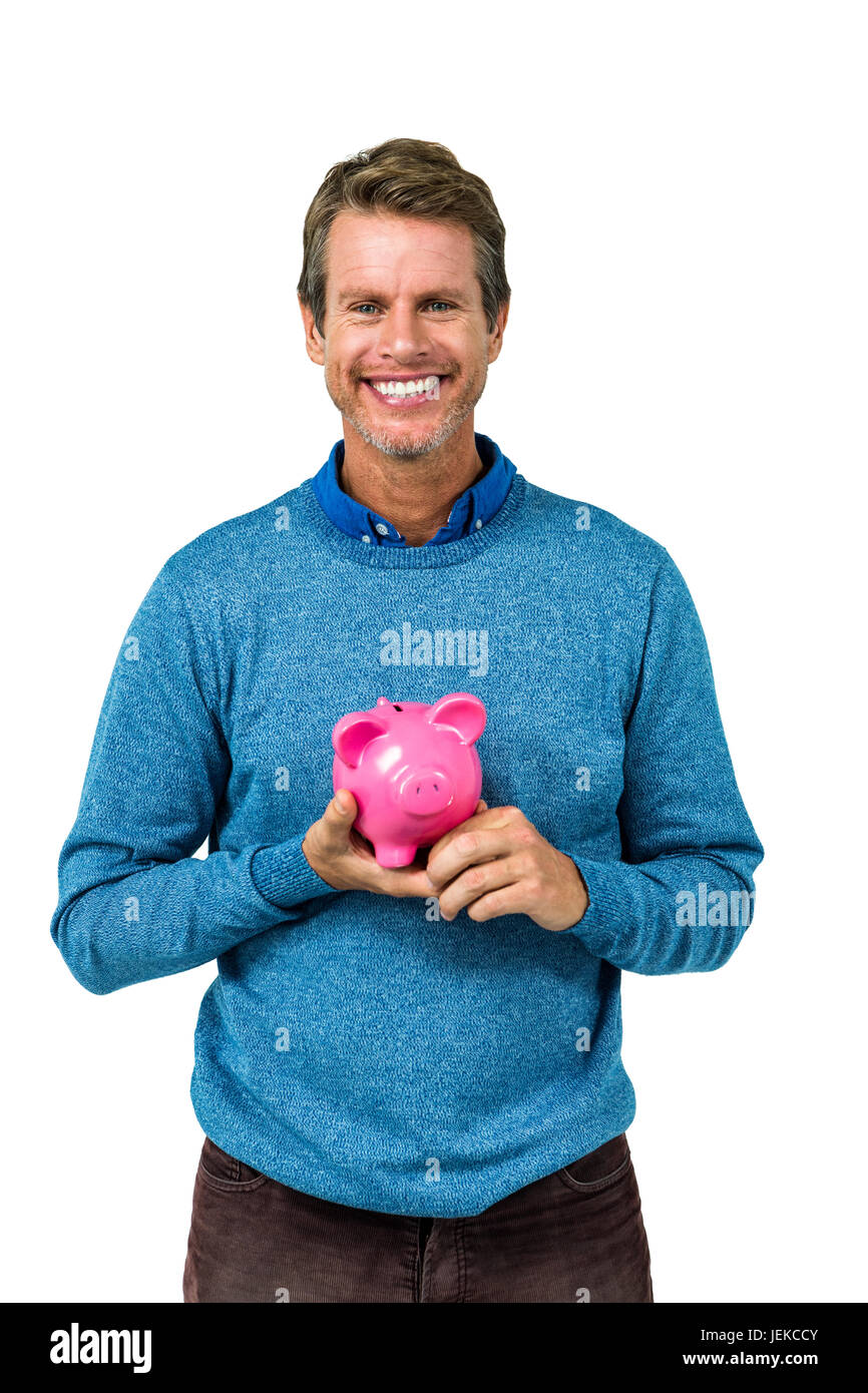 Portrait of smiling man holding piggy bank Stock Photo - Alamy