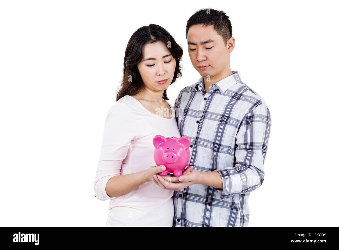 Couple holding their piggy bank Stock Photo - Alamy