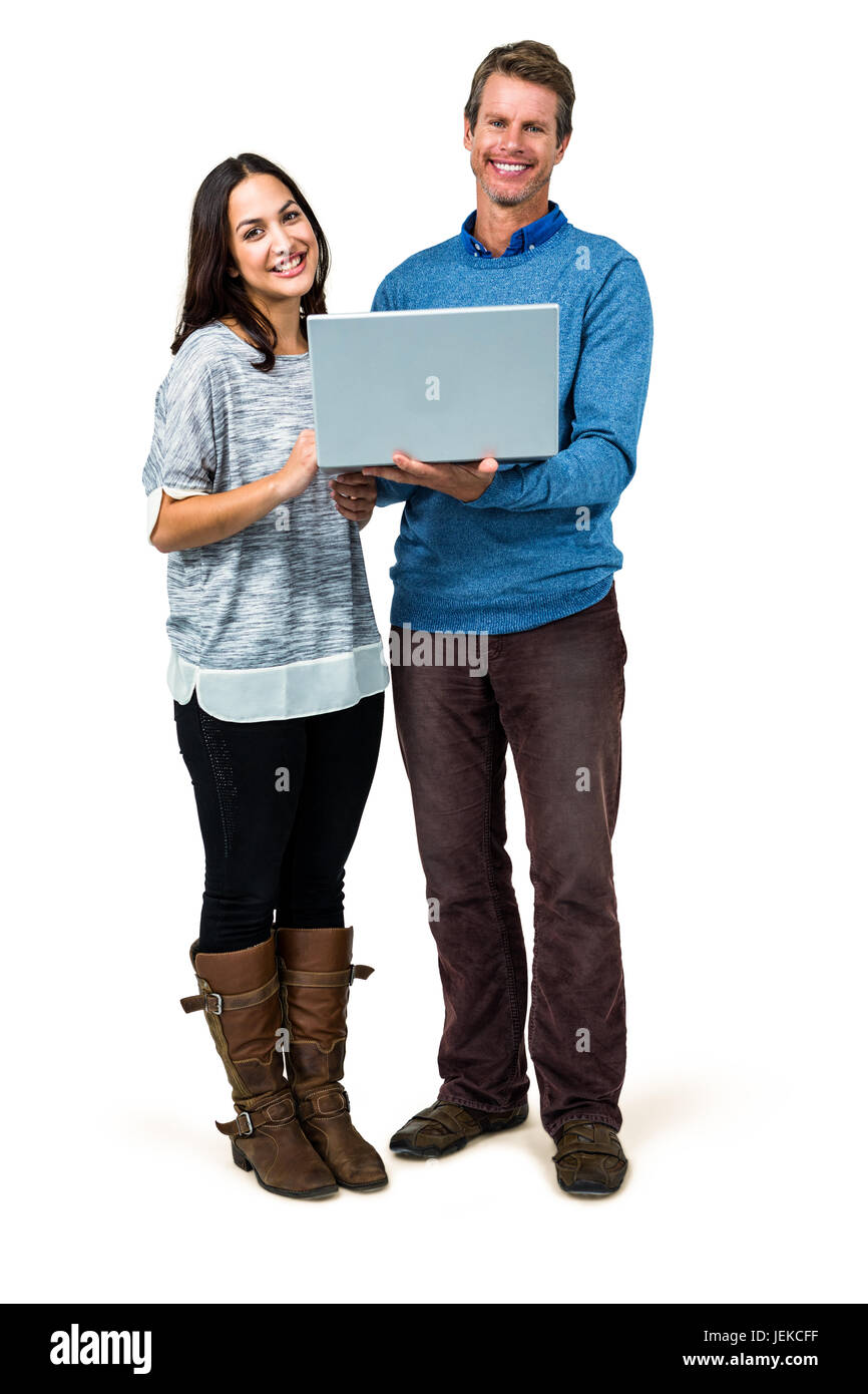 Portrait of smiling couple holding laptop Stock Photo - Alamy