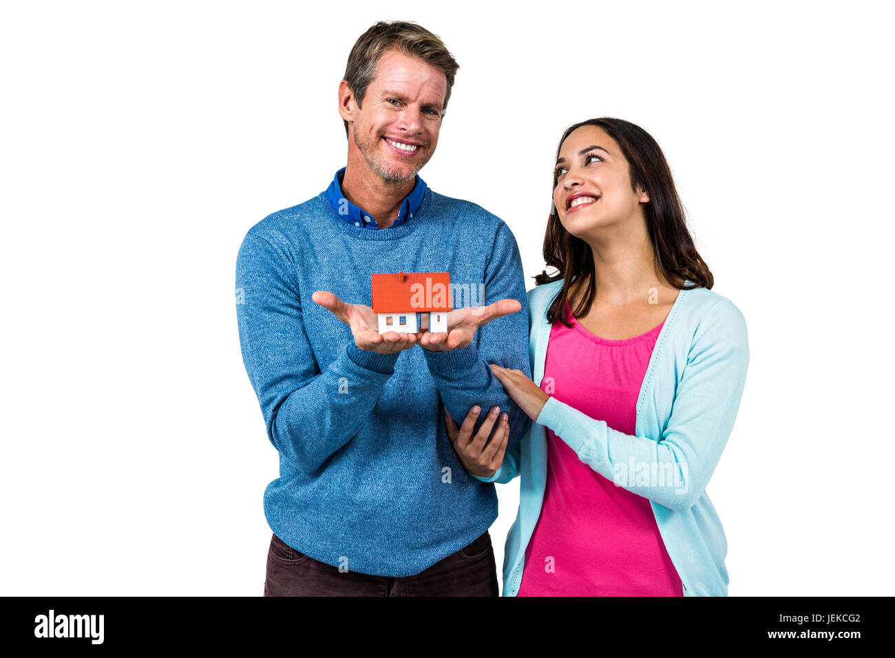 Happy couple holding model house Stock Photo - Alamy