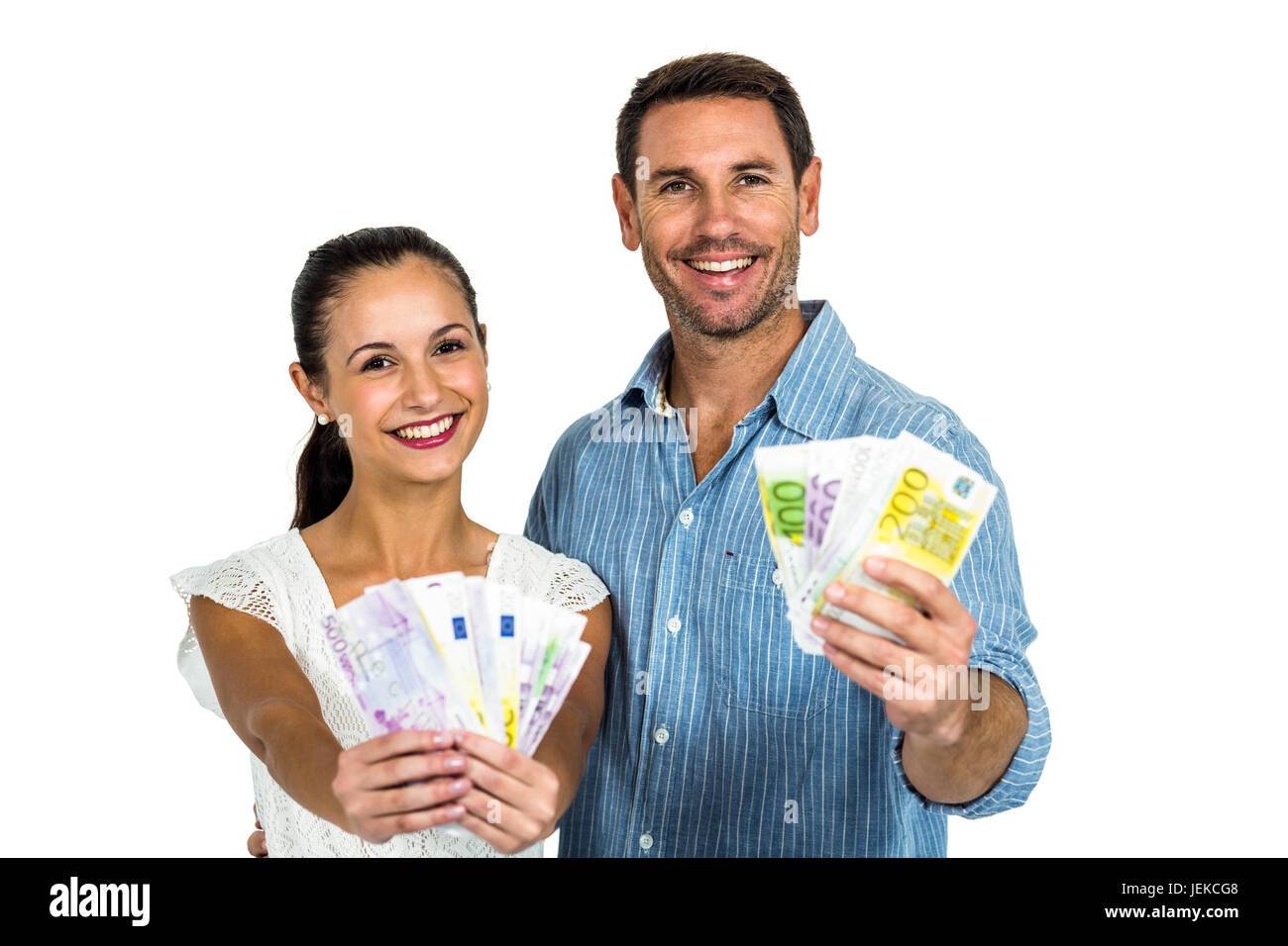 Confident couple holding money Stock Photo - Alamy
