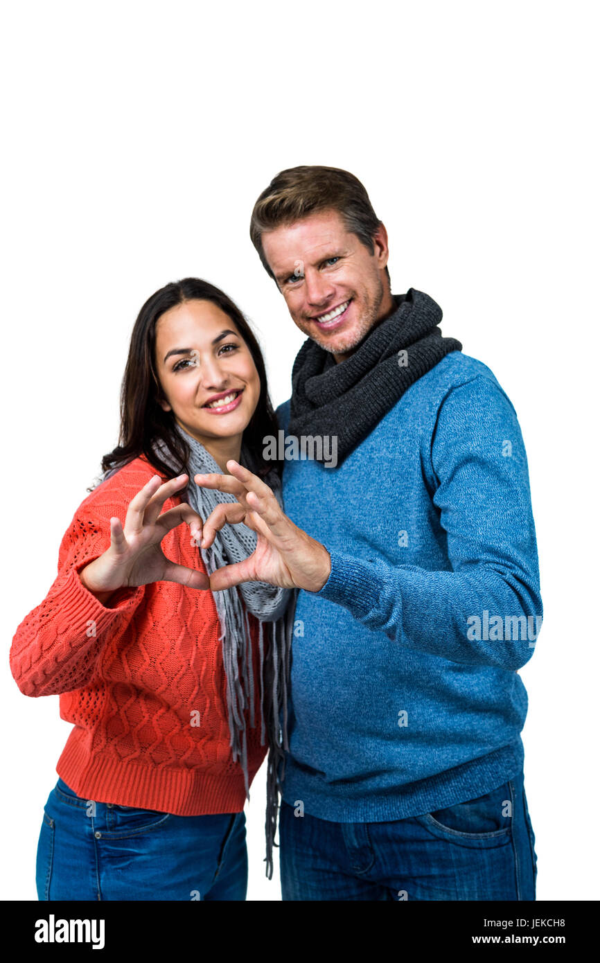 Smiling couple making heart shape with hands Stock Photo - Alamy