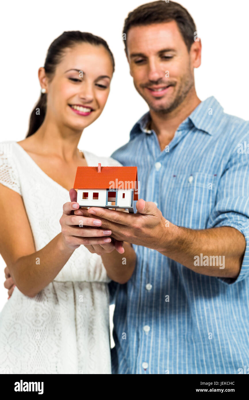 Young couple holding house model Stock Photo - Alamy