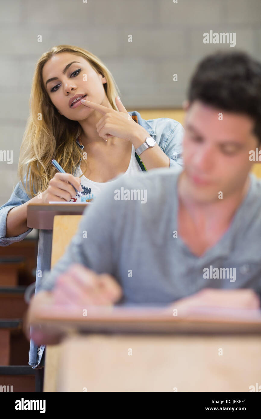 Female student cheating on her classmate Stock Photo
