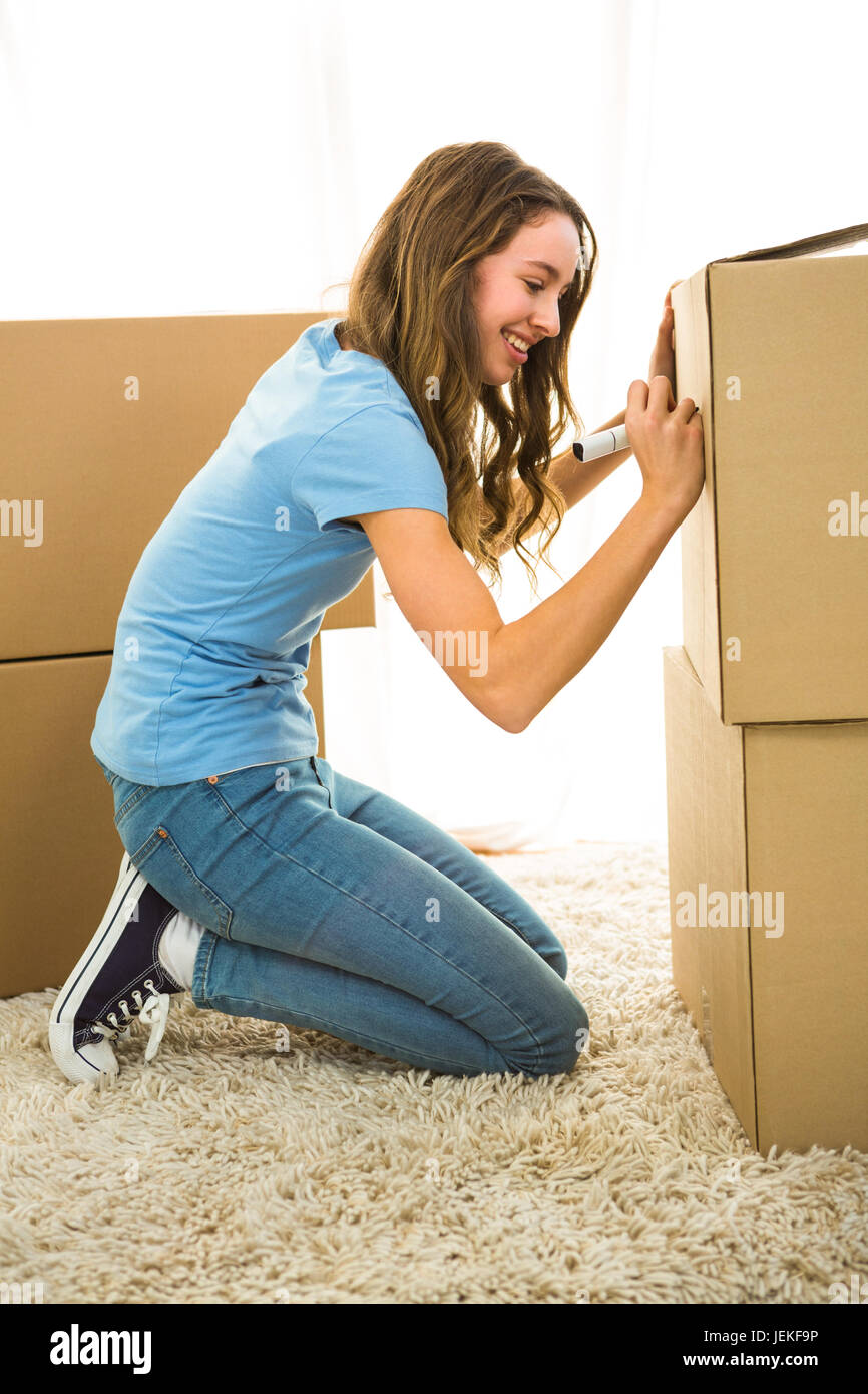 Girl writing on boxes Stock Photo Alamy