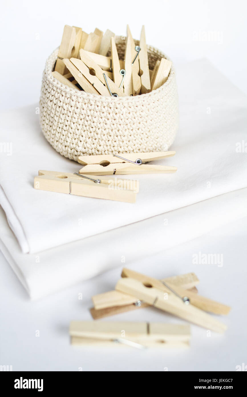 Wooden clothes pegs in knitted basket Stock Photo Alamy