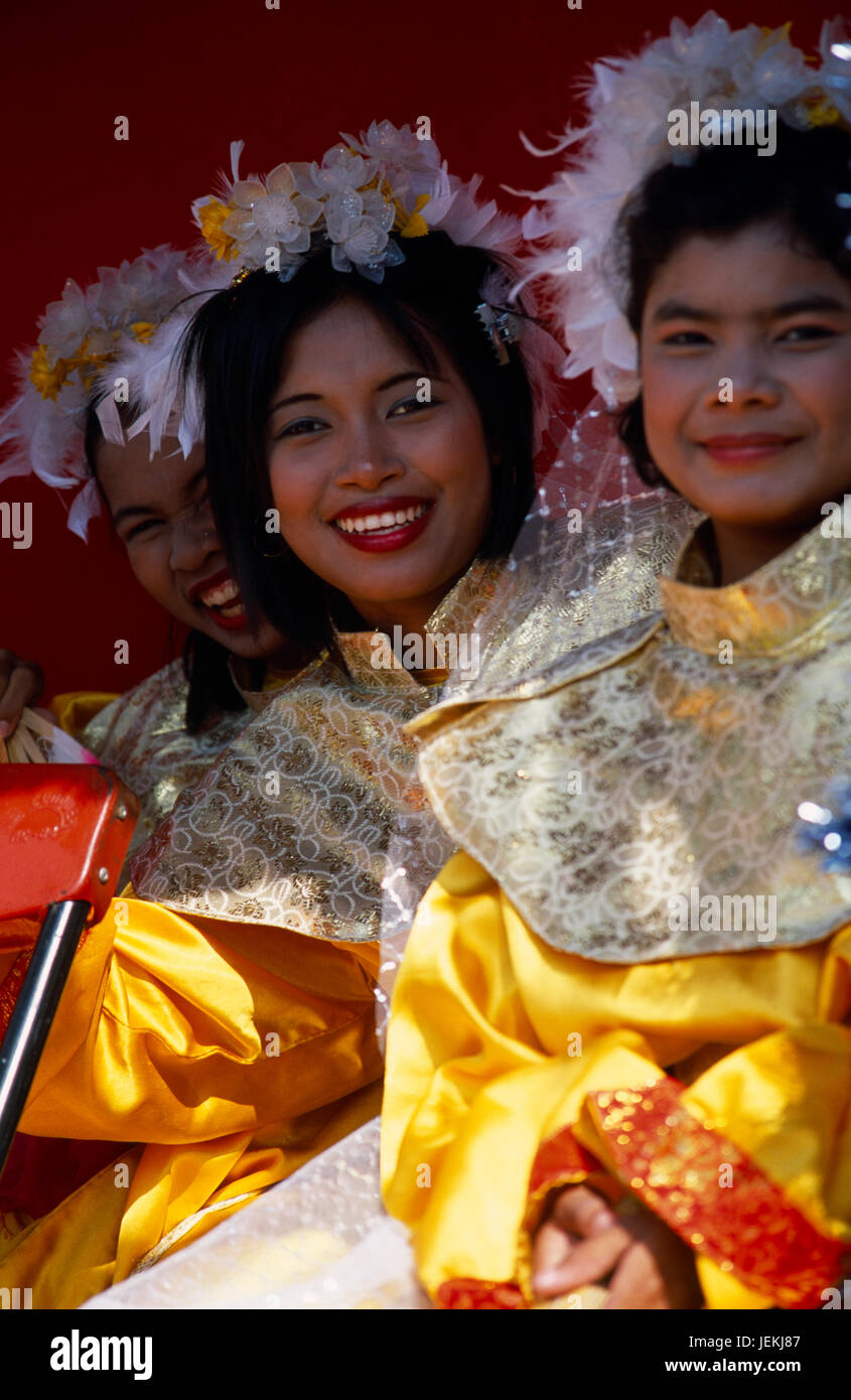 Thailand, North, Chiang Mai, Chinese New Year.  Three smiling young women in costume on processional float. Stock Photo