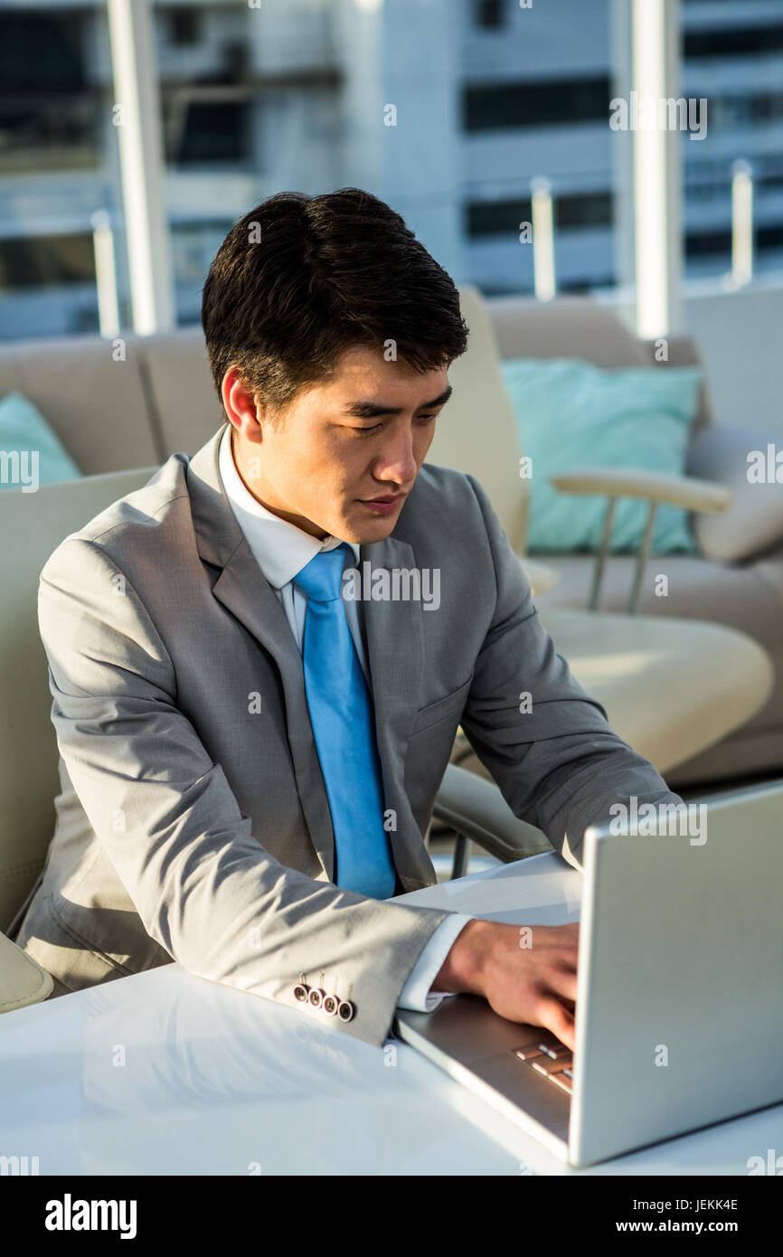 Asian businessman using his computer Stock Photo - Alamy