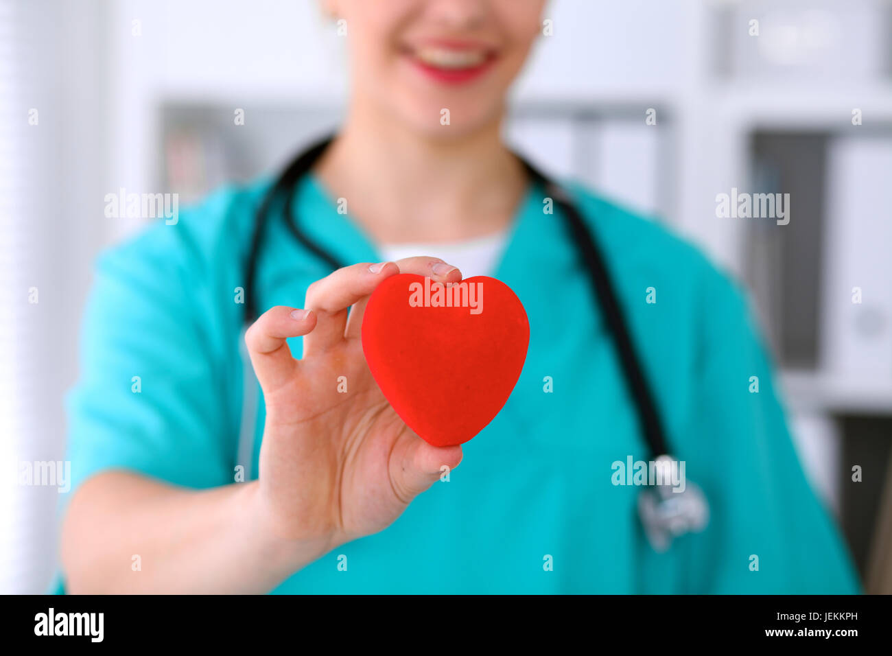 Female surgeon doctor with stethoscope holding heart Stock Photo - Alamy