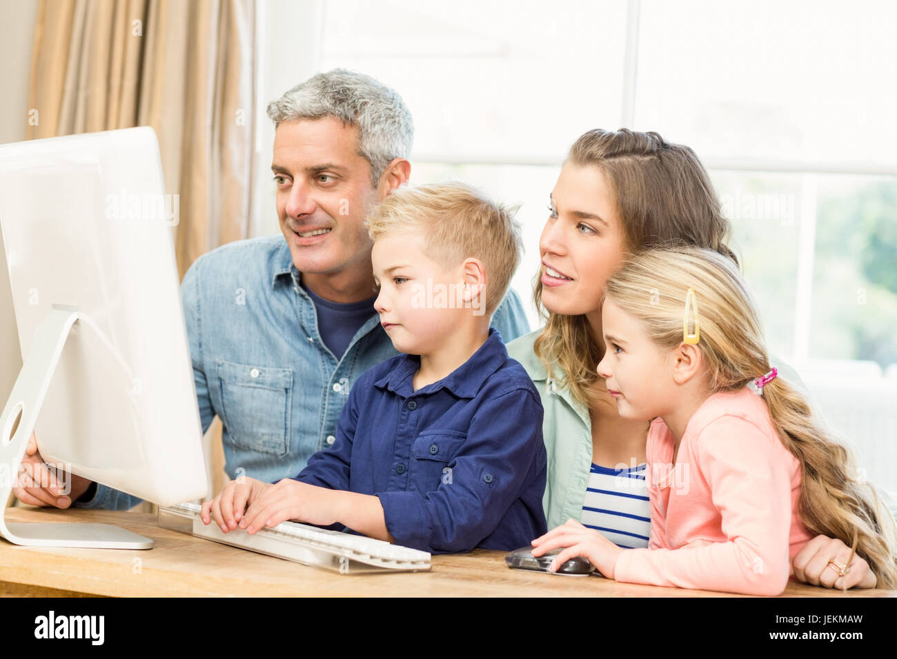 Happy family using the computer Stock Photo - Alamy