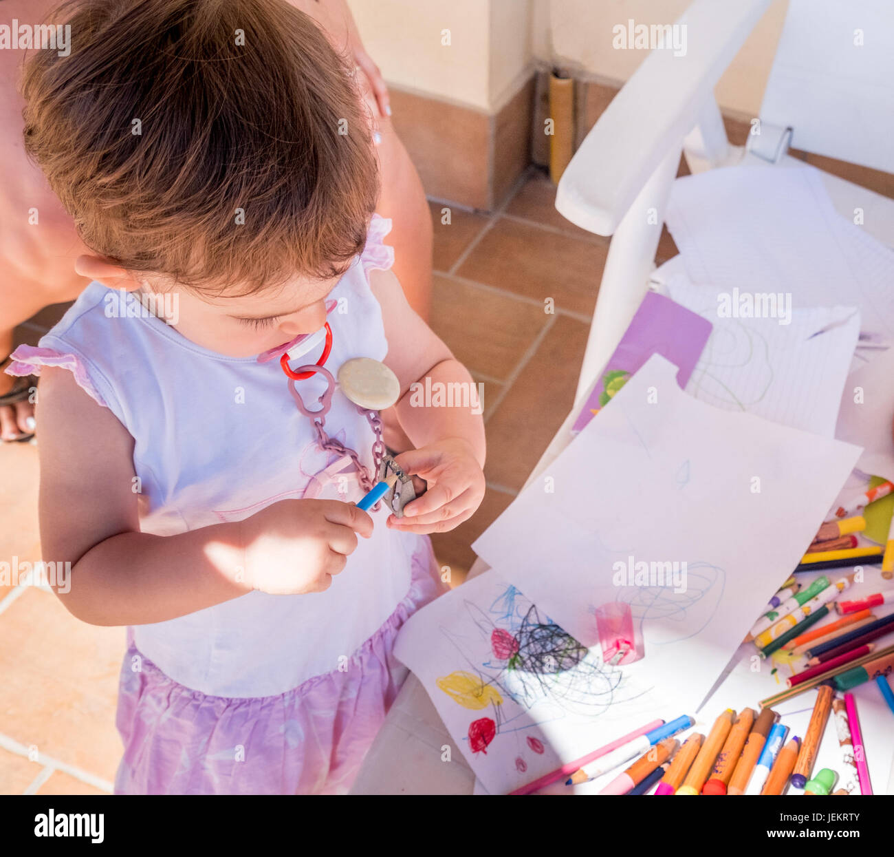 baby girl sharpening pencil Stock Photo Alamy