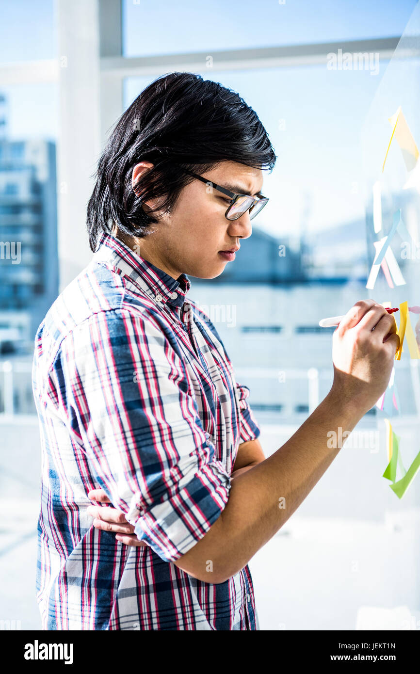 Creative businessman writing on sticky notes Stock Photo - Alamy