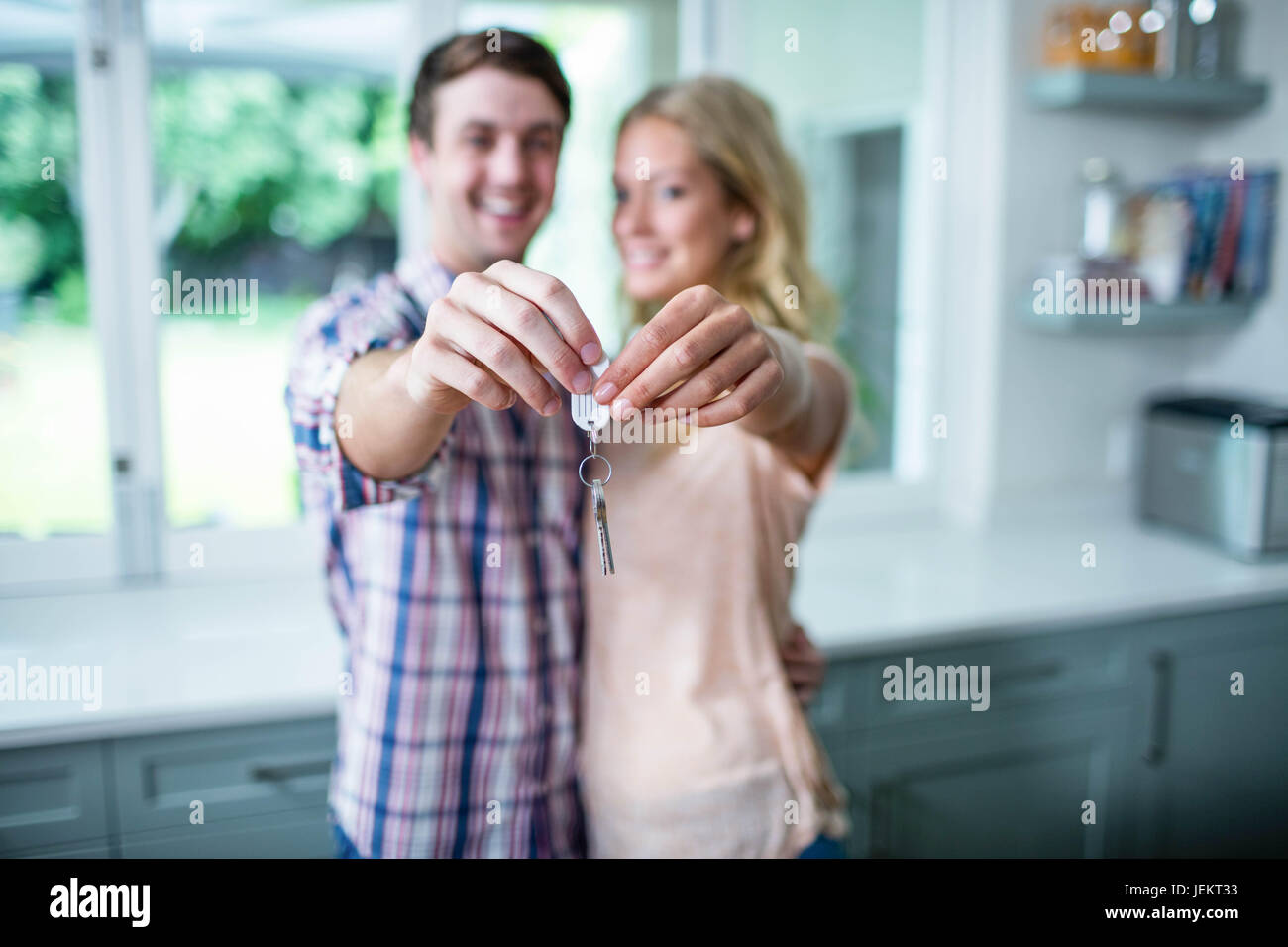 Cute couple showing their new home keys Stock Photo - Alamy