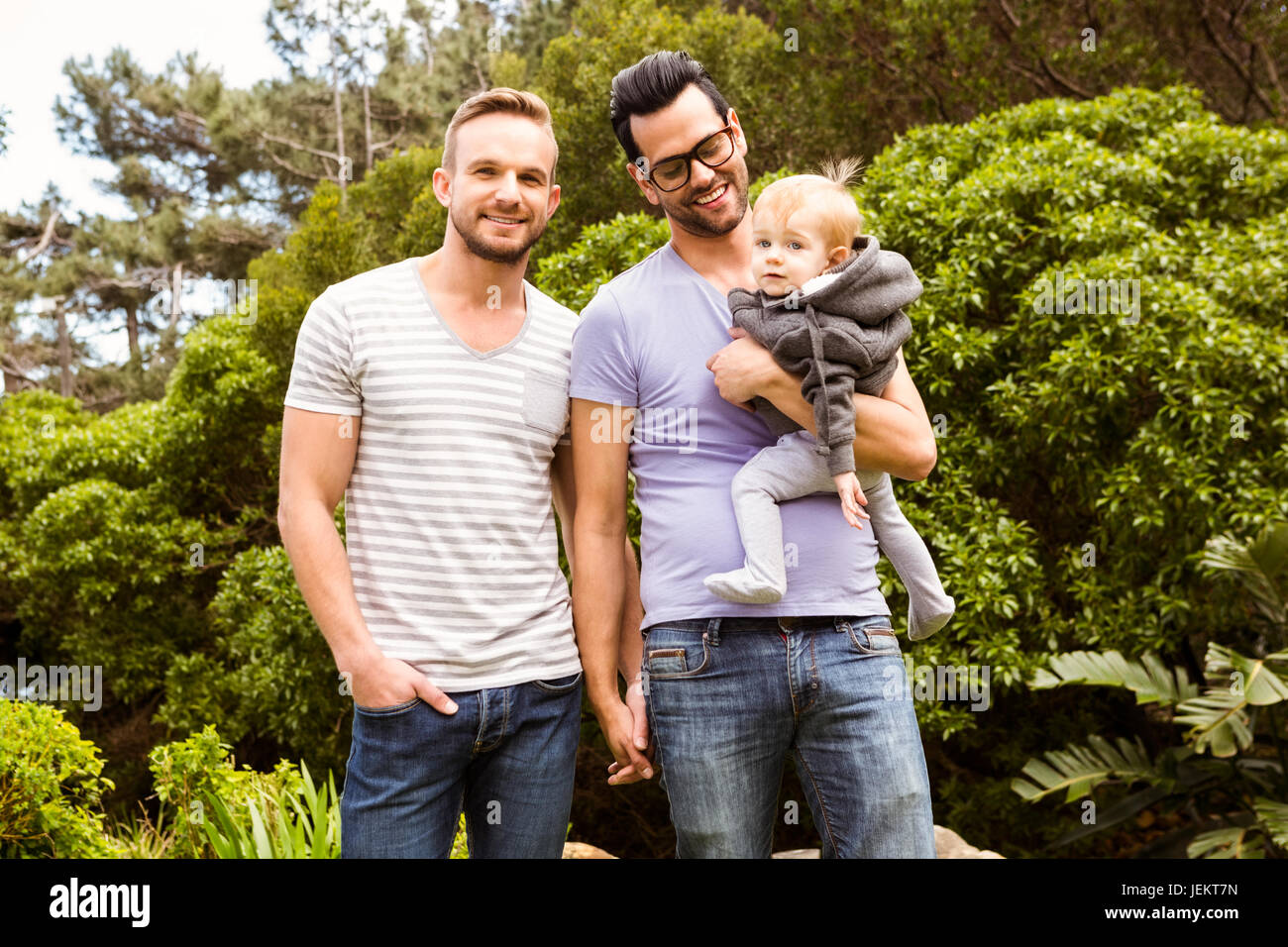 Smiling gay couple with child Stock Photo