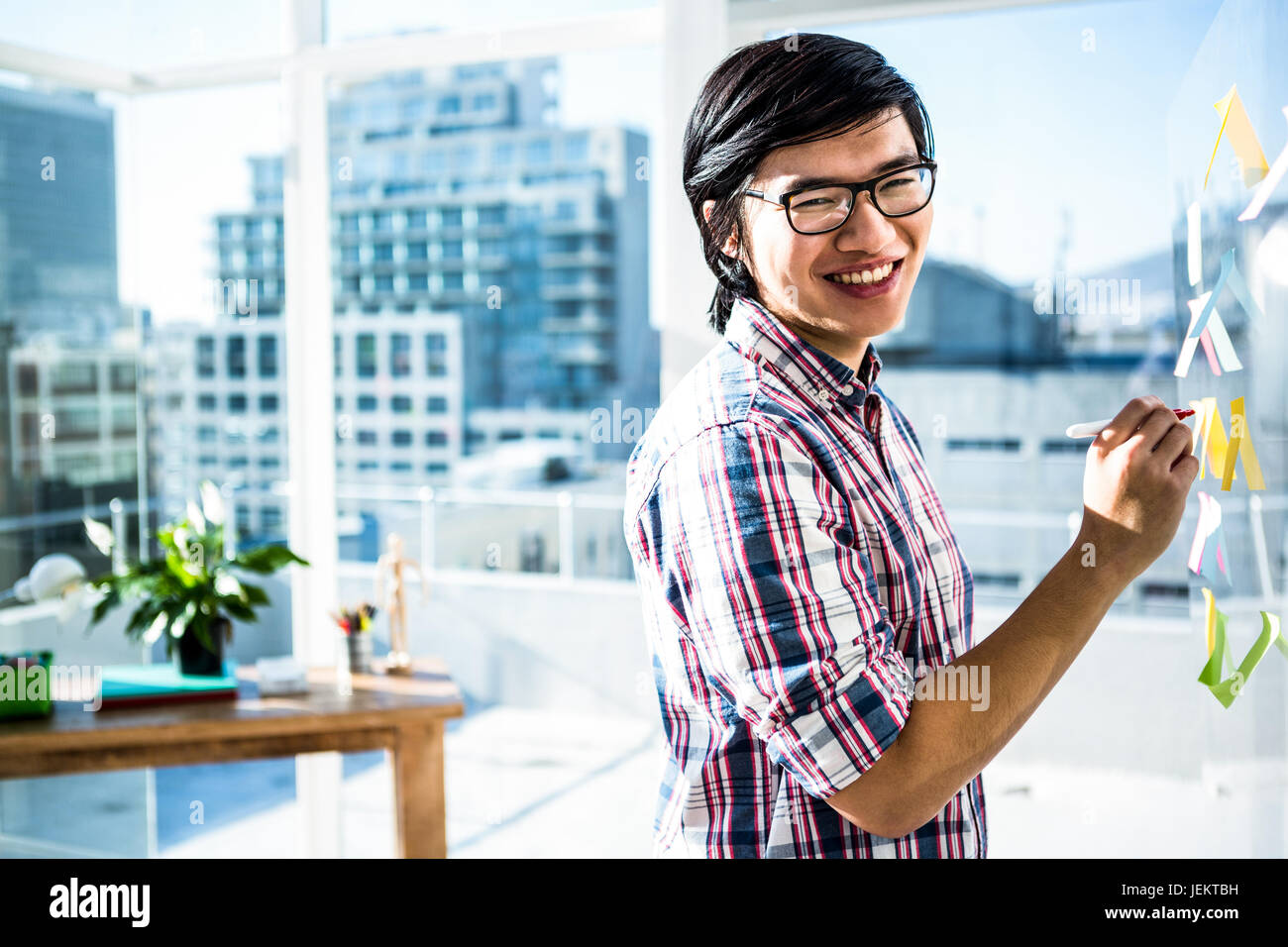 Creative businessman writing on sticky notes Stock Photo - Alamy