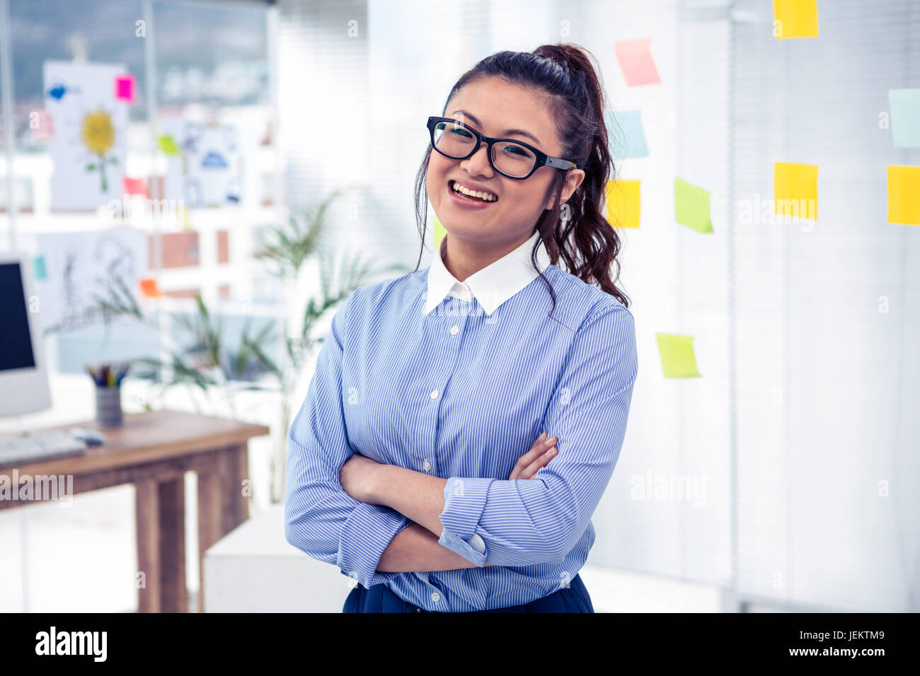 Smiling Asian businesswoman with arms crossed Stock Photo - Alamy