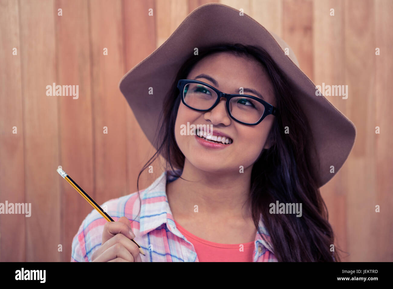 Woman thinking holding pencil hi-res stock photography and images - Alamy