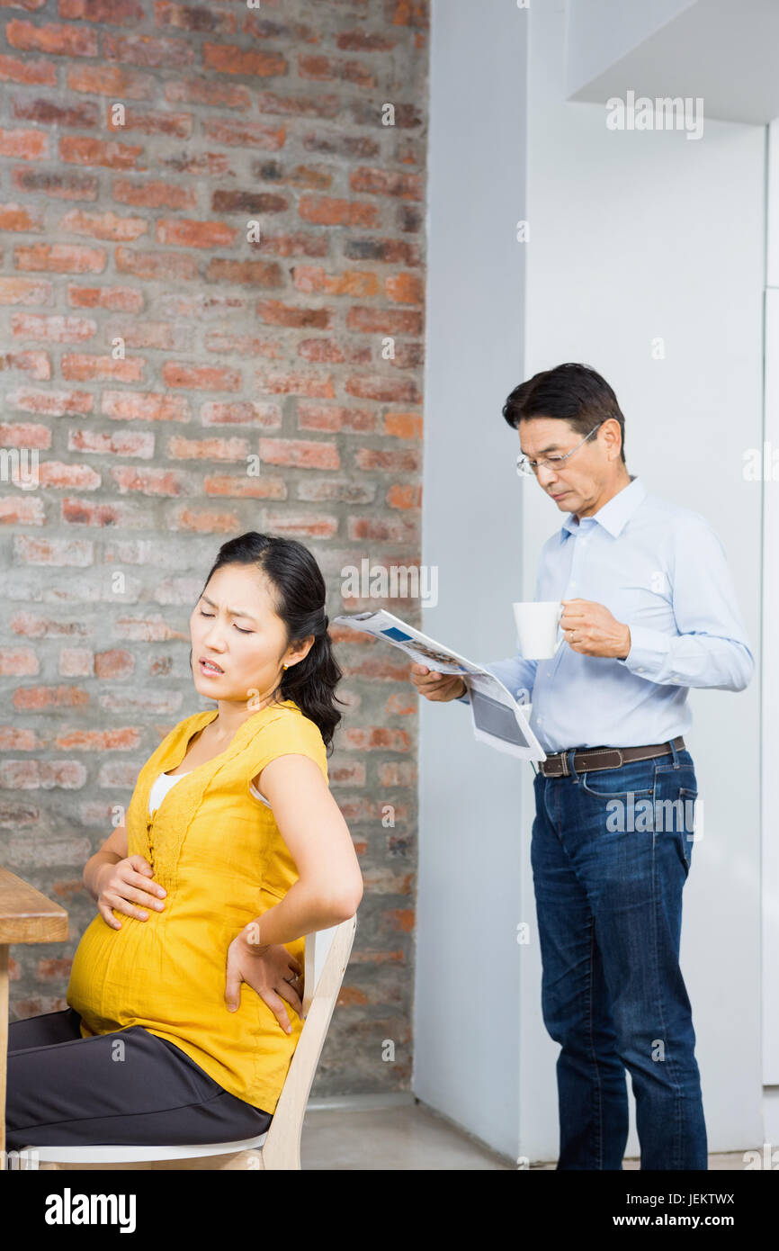 Suffering pregnant woman sitting on chair Stock Photo Alamy