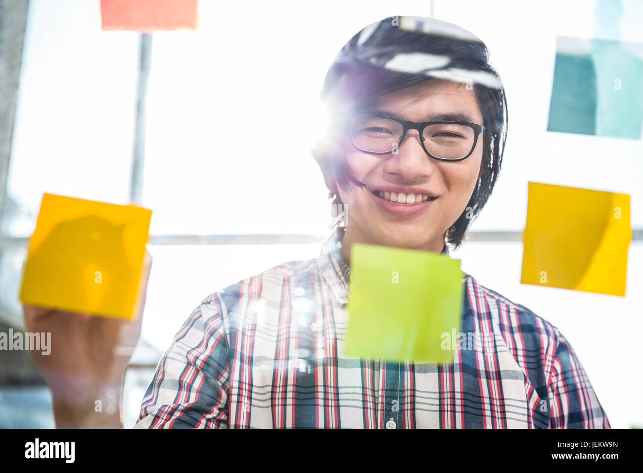 Creative businessman writing on sticky notes Stock Photo - Alamy