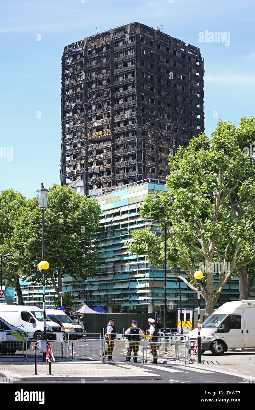 The burnt-out shell of Grenfell House, London, UK. The 23 storey residential block was destroyed by fire, June 2017. Police guard the area. Stock Photo