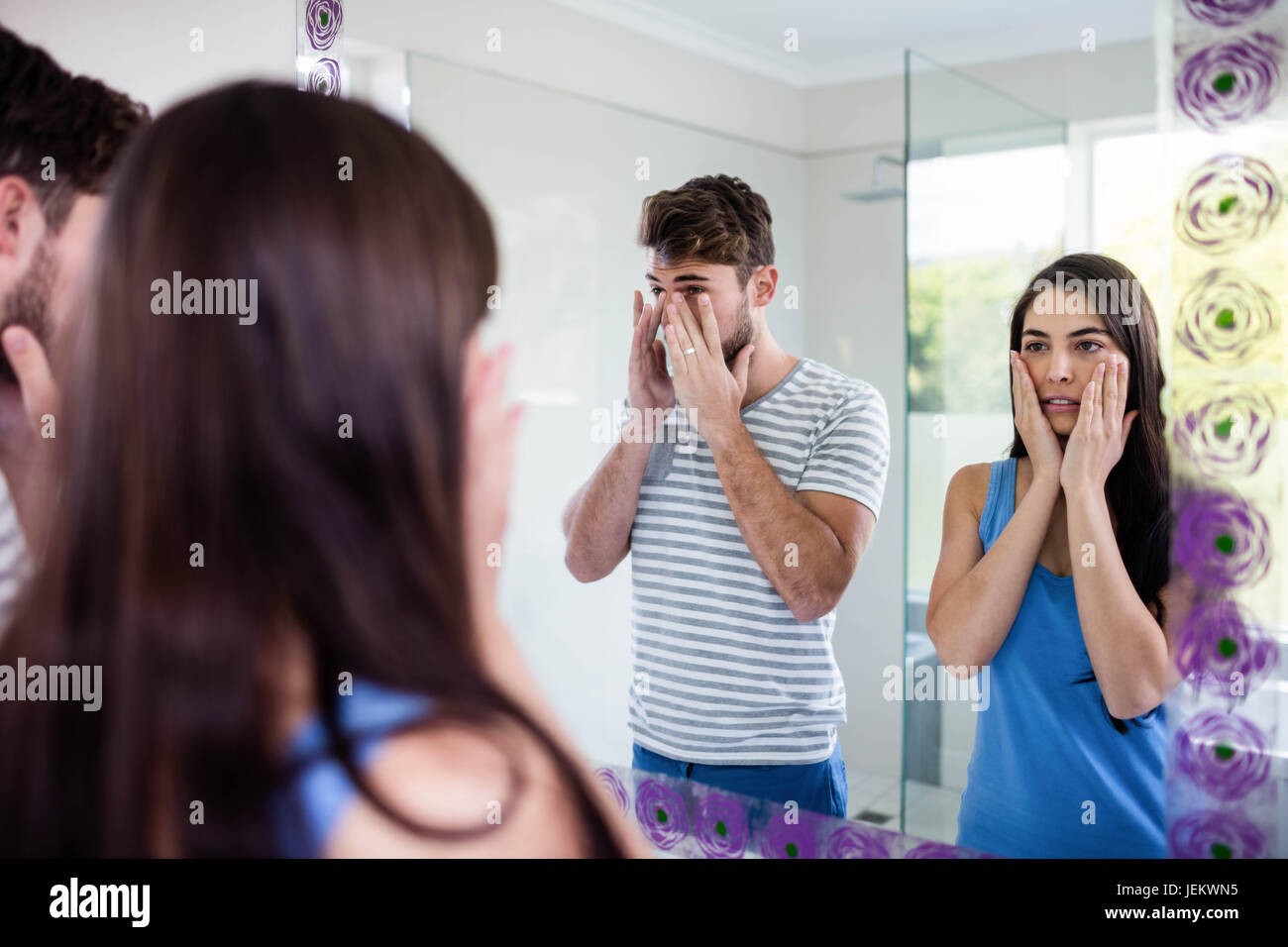Couple looking themselves in the mirror Stock Photo Alamy