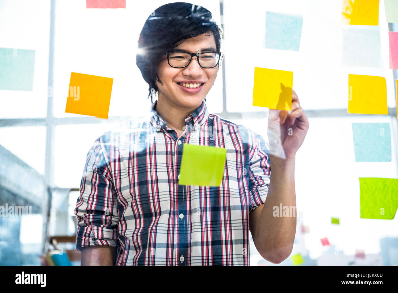 Creative businessman writing on sticky notes Stock Photo - Alamy