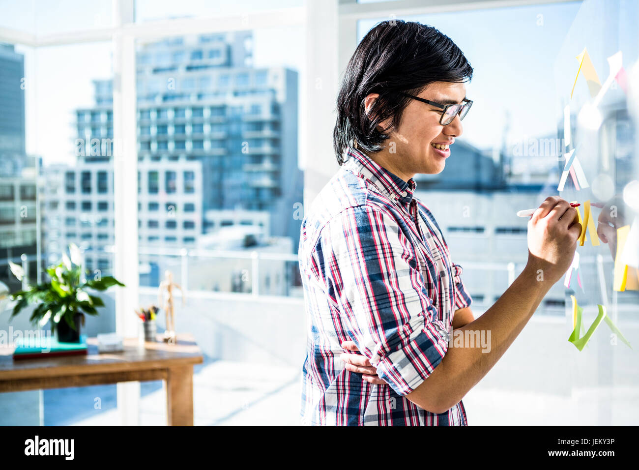 Creative businessman writing on sticky notes Stock Photo - Alamy