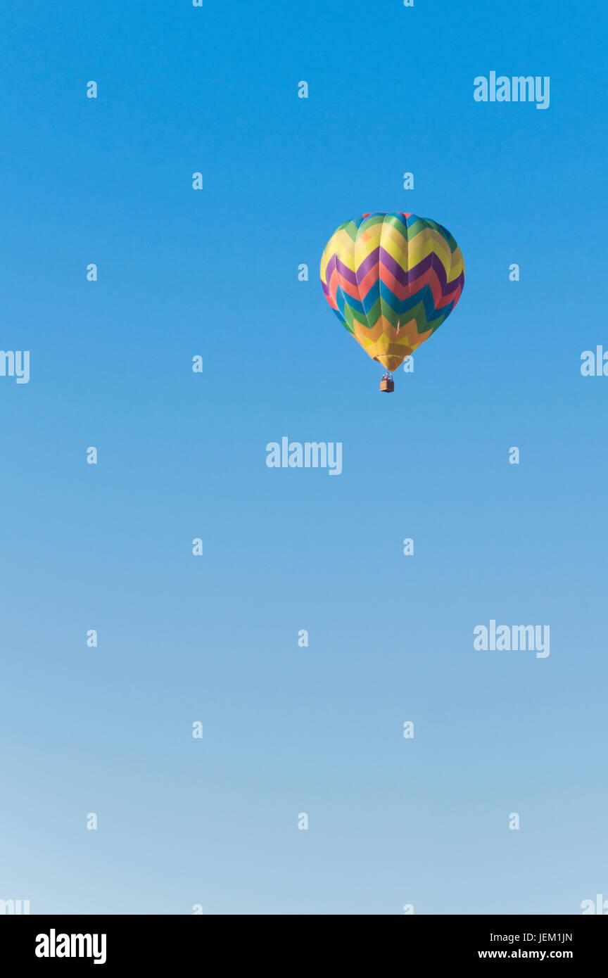 Isolated Hot Air Balloon in a blue sky Stock Photo - Alamy