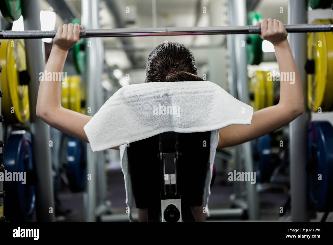 Fit woman lifting the barbell bench press Stock Photo - Alamy