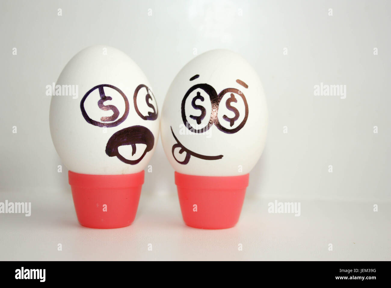 Business concept. Eggs with painted face. Photo for your design Stock Photo