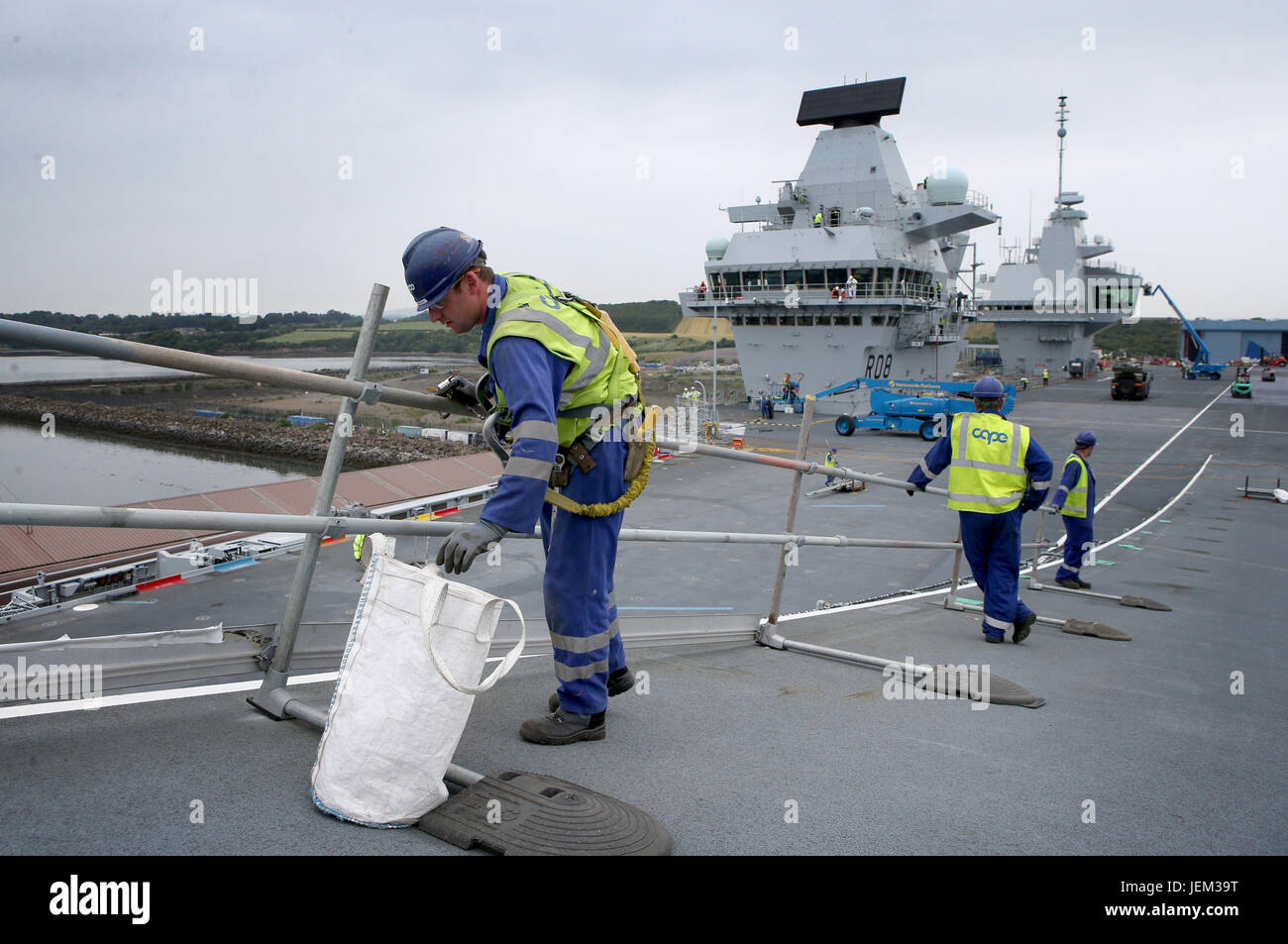 Final preparations are made by engineers and crew on the flight deck ahead of sea trials this summer, for the Royal Navy's new aircraft carrier HMS Queen Elizabeth, at Rosyth Dockyard in Dunfermline. Stock Photo
