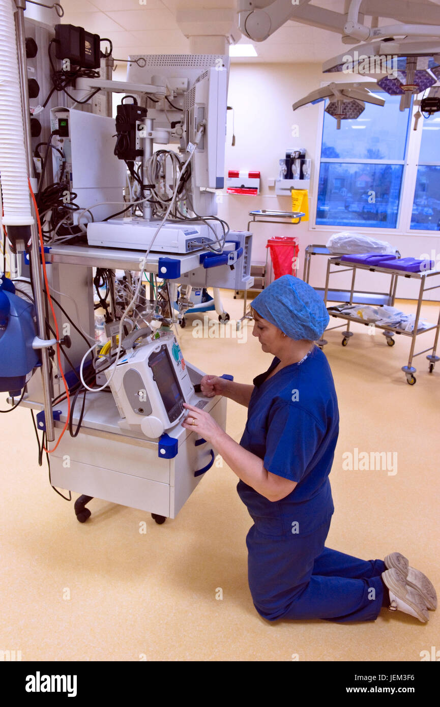 Before a hospital surgical session, an ODP anaesthetics practitioner prepares and checks correct functioning an any equipment which may be used. Stock Photo