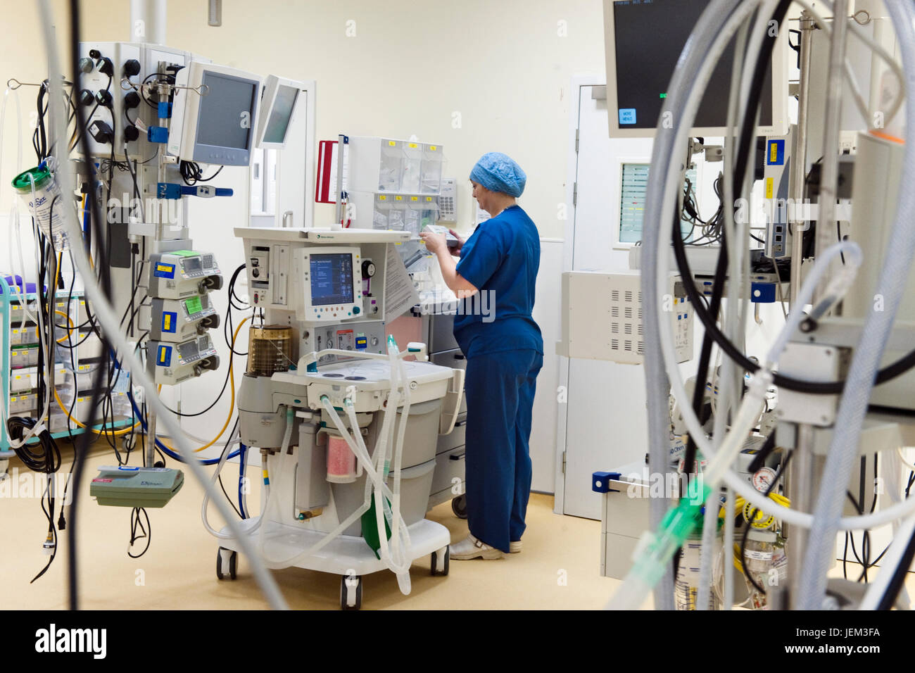 Before a hospital surgical session, an ODP anaesthetics practitioner prepares and checks correct functioning an any equipment which may be used. Stock Photo
