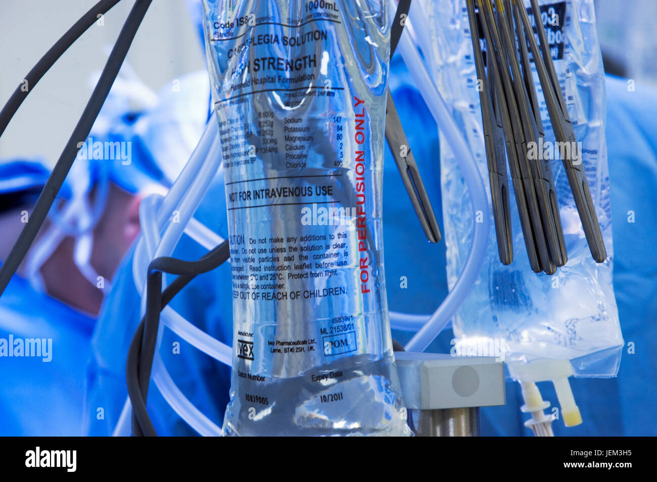 A high-strength cardioplegia solution hangs on a drip stand during a cardiac operation for infusion into the patient's circulation. Stock Photo