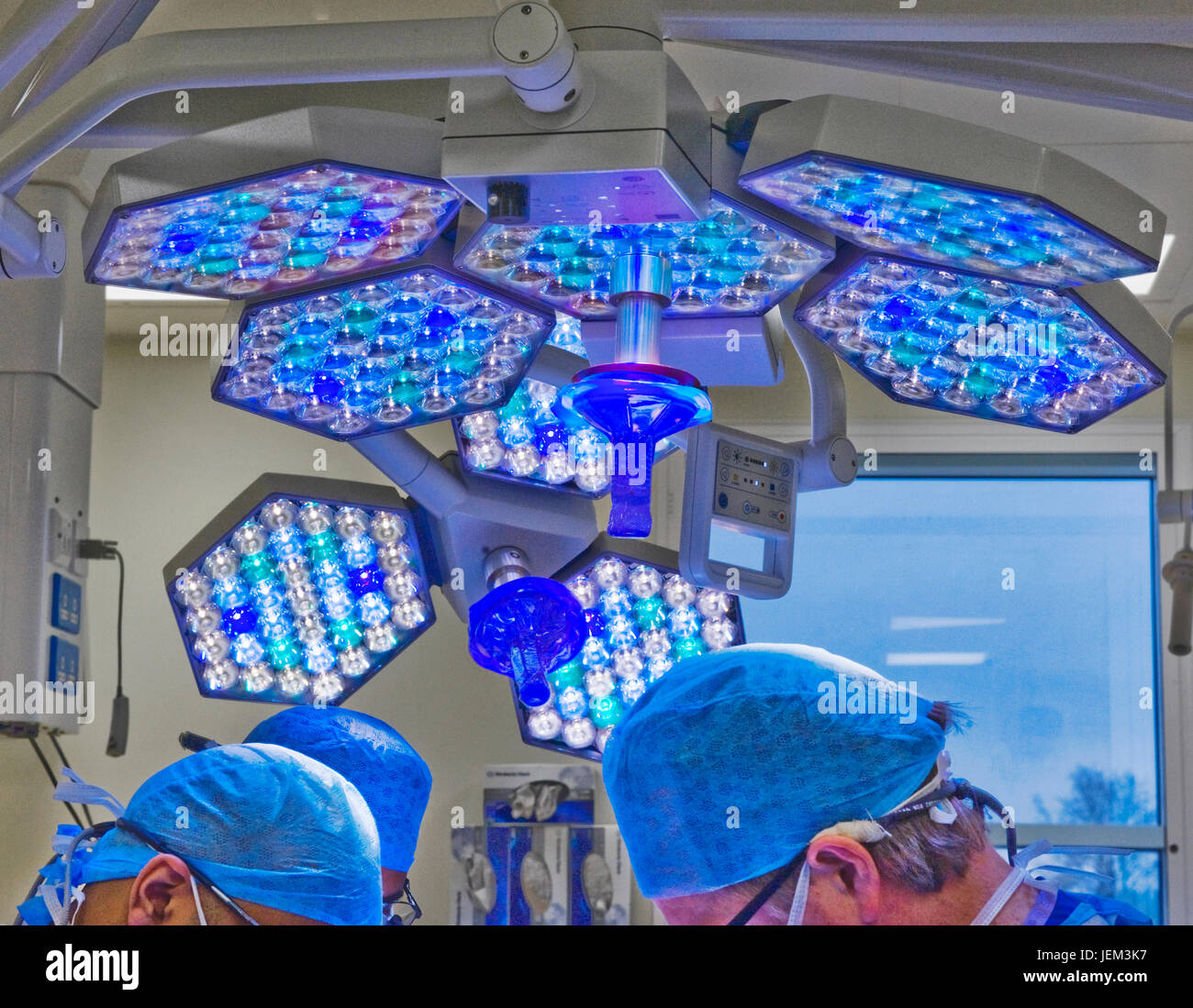 Surgical team work using cool directional lighting Stock Photo