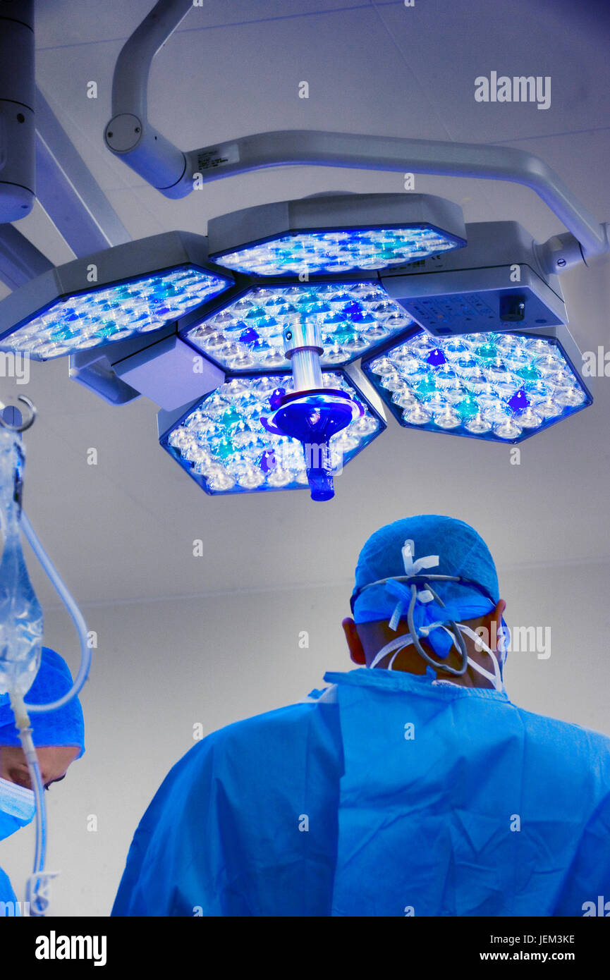 Surgical team work using cool directional lighting Stock Photo