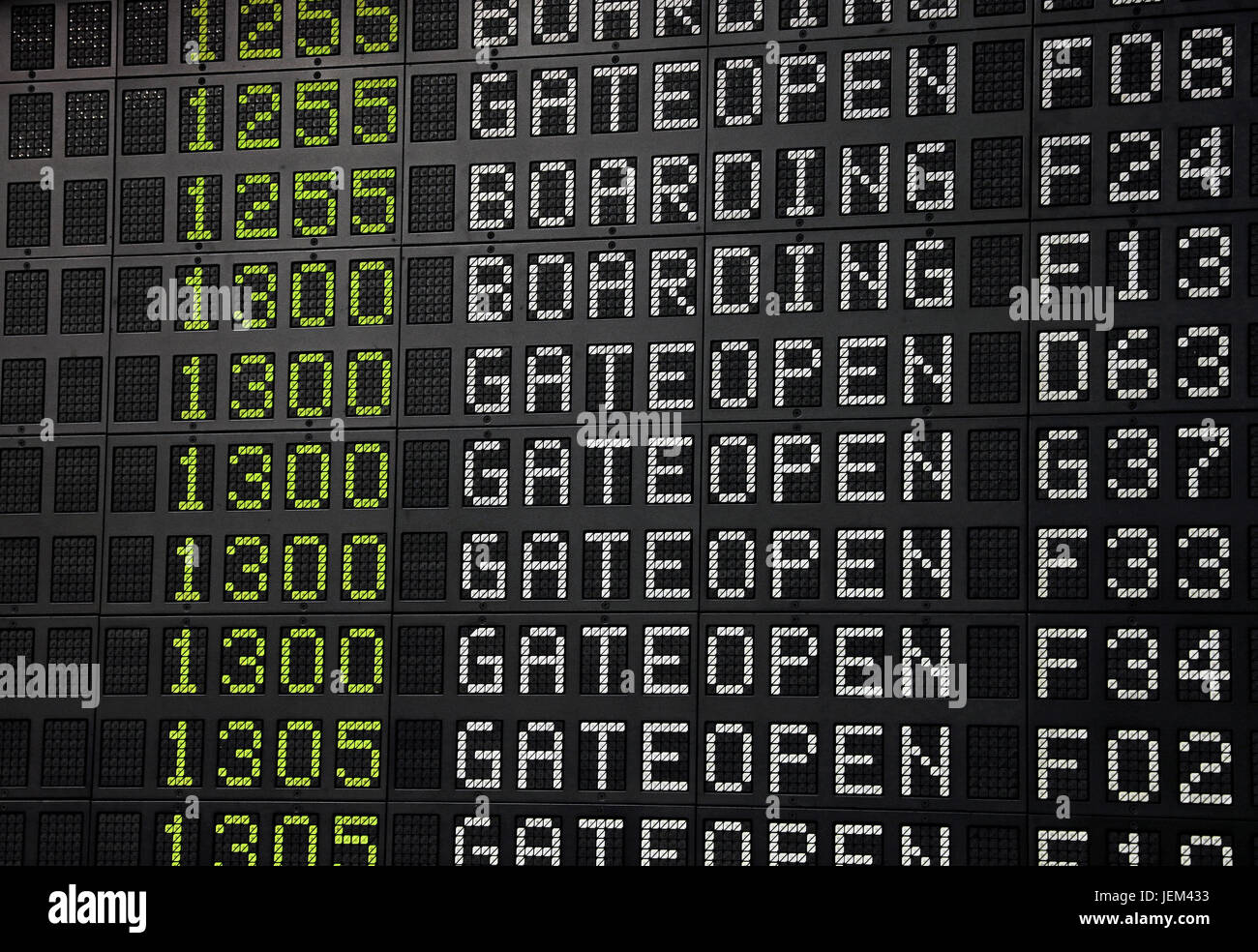Flight information panel desk at airport, with time, flight number, boarding and gate open messages, close up, low angle view Stock Photo