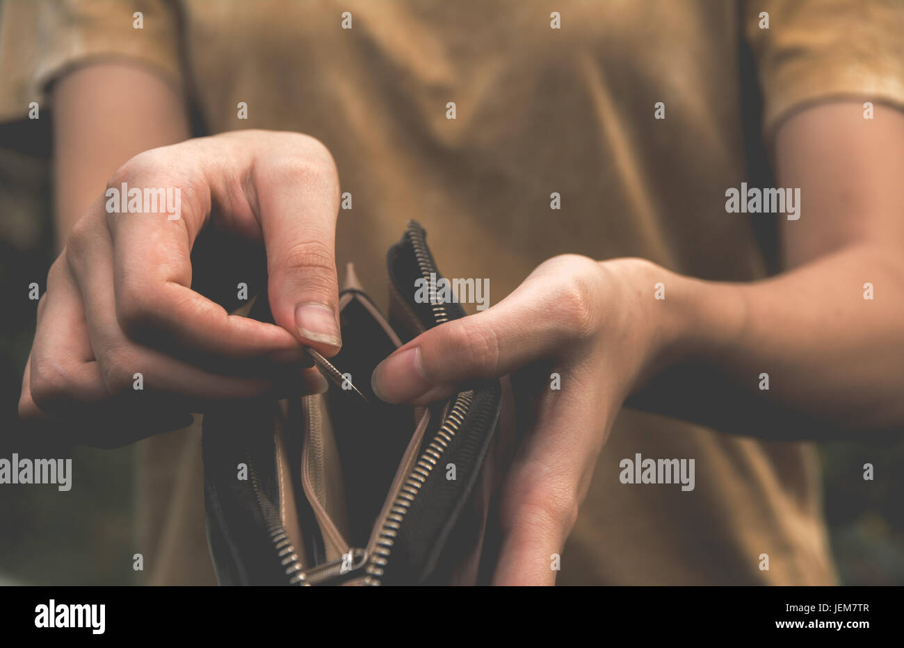 Close-up woman standing and holding money coin with wallet empty of ...