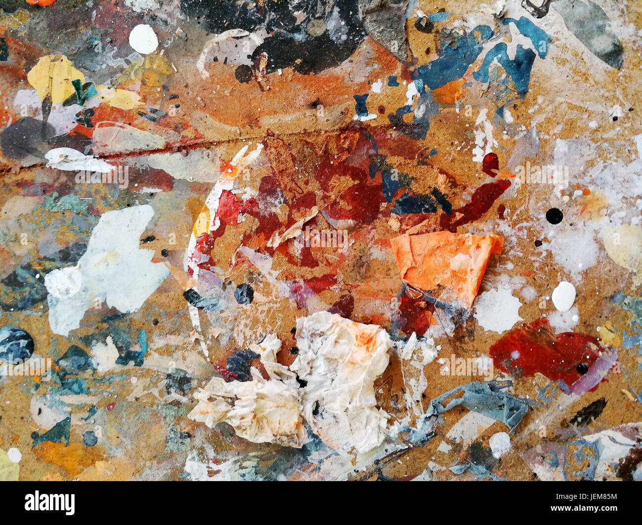 Chipboard on which it has been randomly painted with various colors of different types, forms a harmonious and multicolored design. Stock Photo