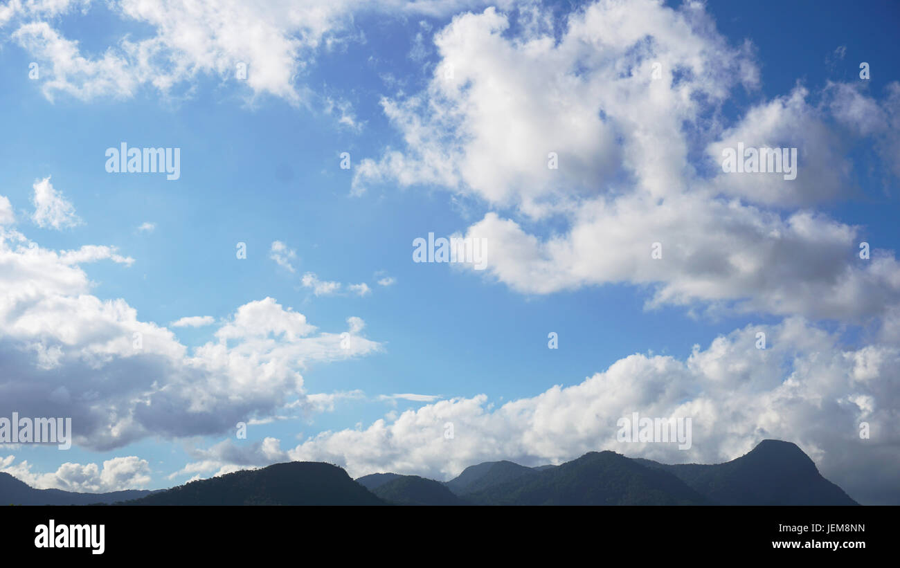 Blue sky with clouds over mountains Stock Photo - Alamy