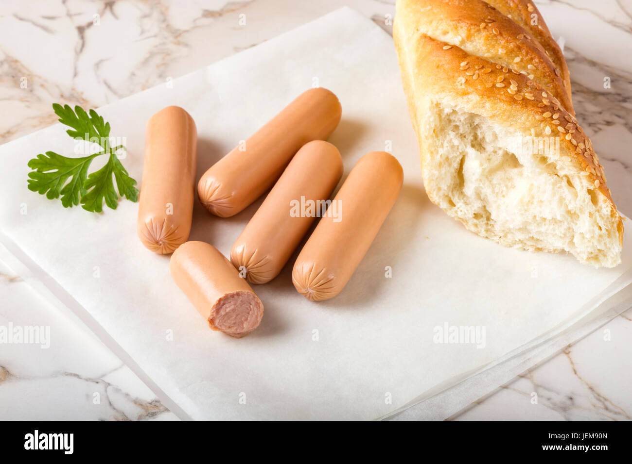 Sausages (Frankfurter) on rustic table with bread Stock Photo