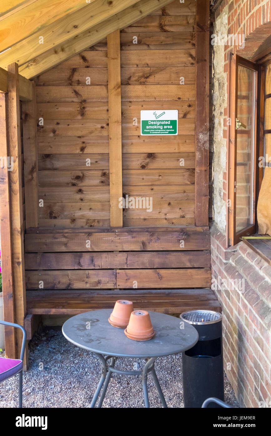Designated smoking area outside pub timber structure sign signage ashtray Kent Stock Photo Alamy