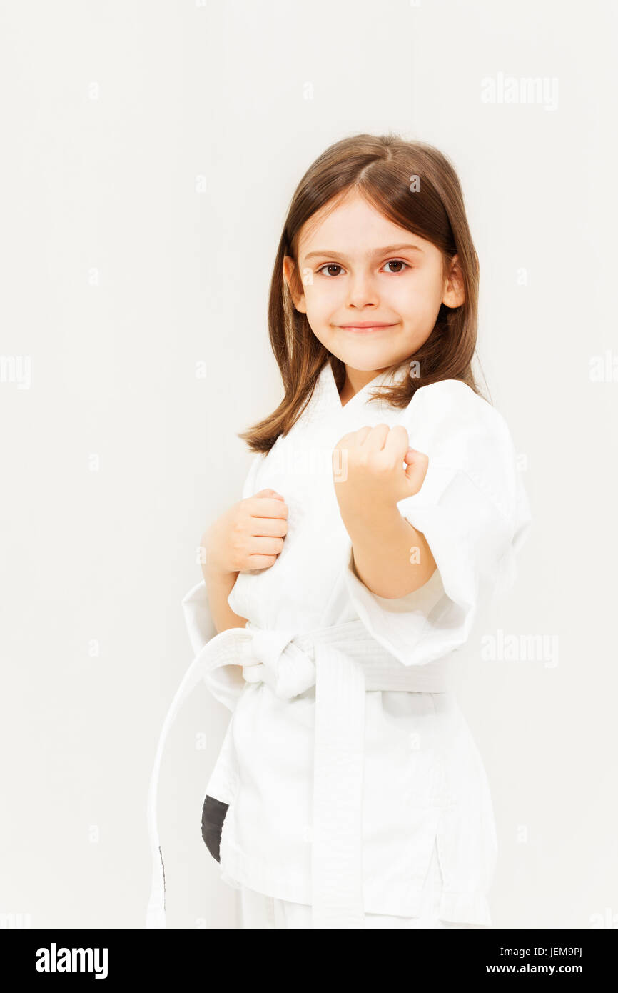 Little girl in white kimono training karate Stock Photo