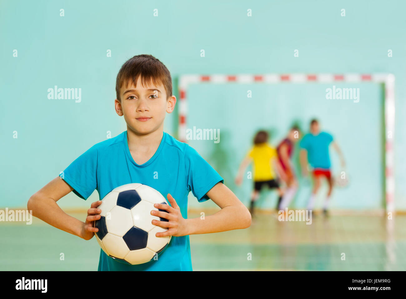 Young football player ready to throw soccer ball Stock Photo