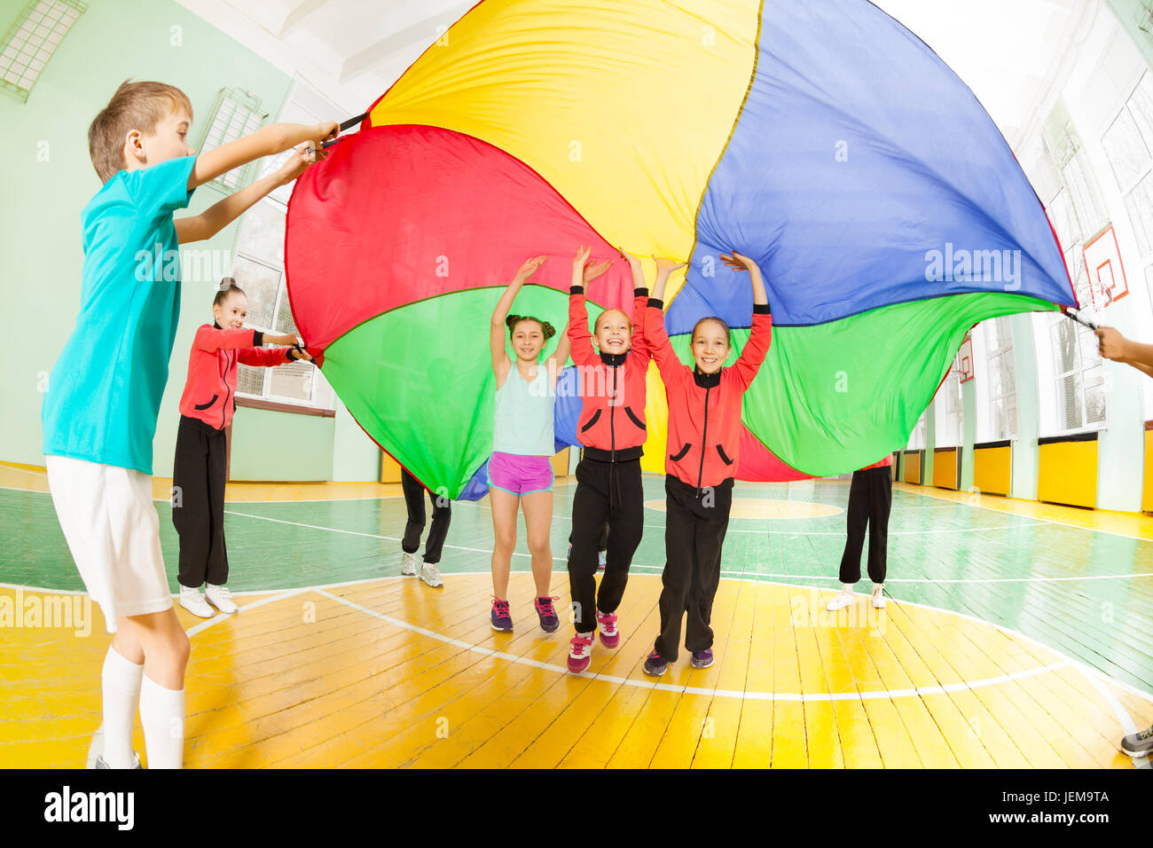 Children playing parachute games in sports hall Stock Photo Alamy