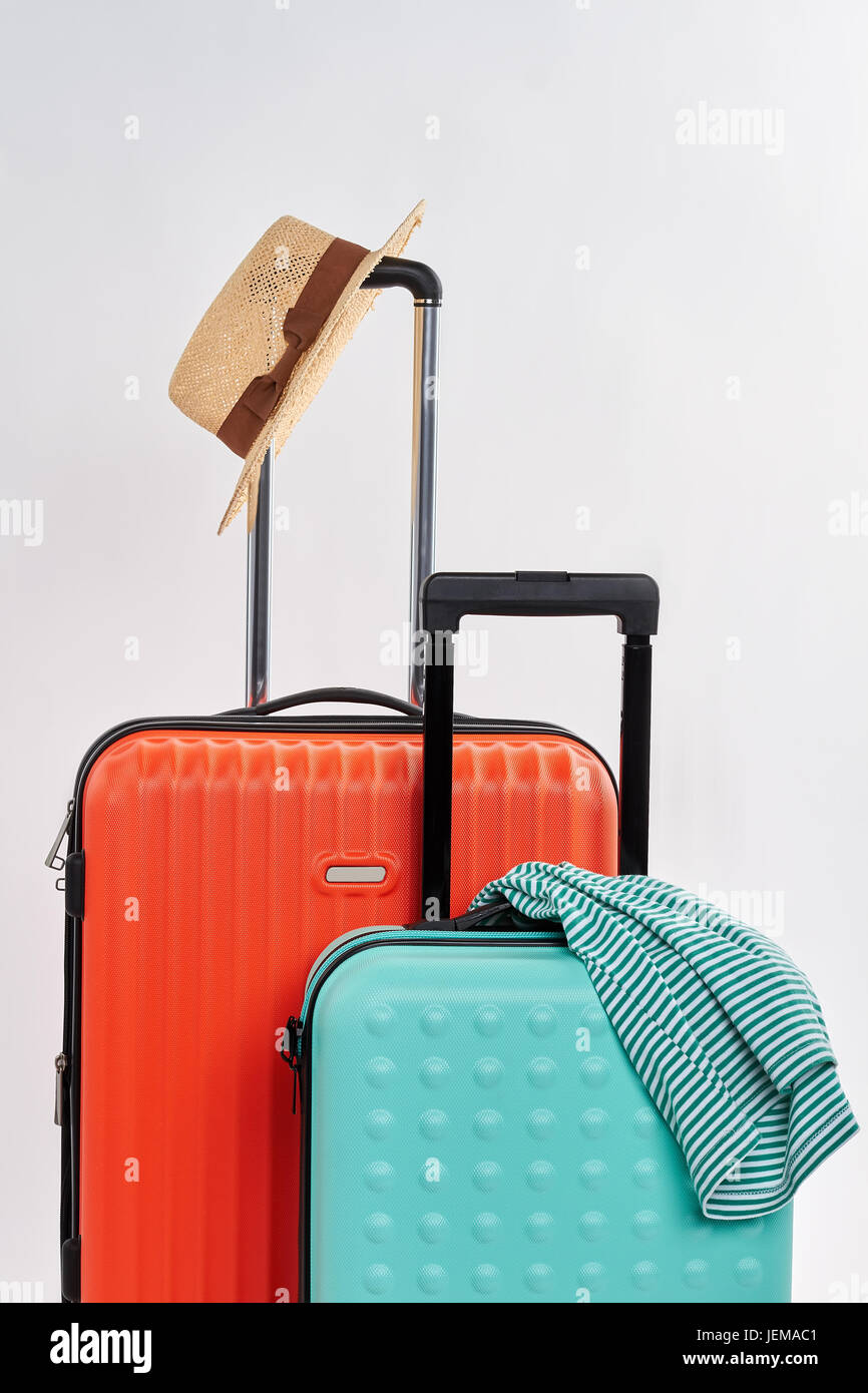 Suitcases and clothes for journey. Summer accessories for travelling