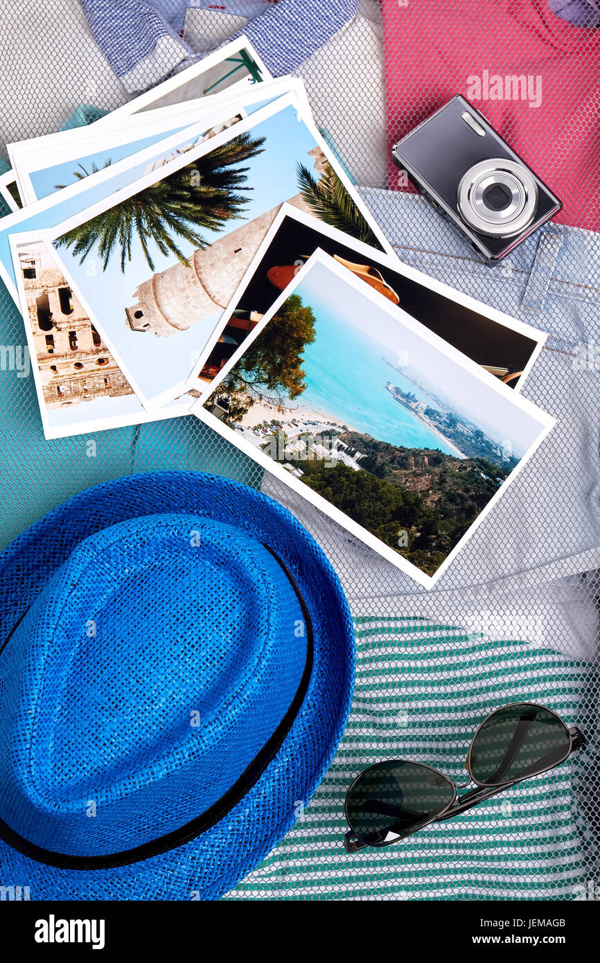 Personal things for vacation close up. Hat, glasses, camera, photos, clothes. Stock Photo