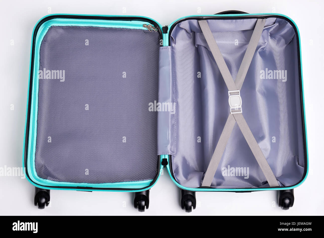 Large open fashionable suitcase. Empty luggage on wheels for journey. Stock Photo