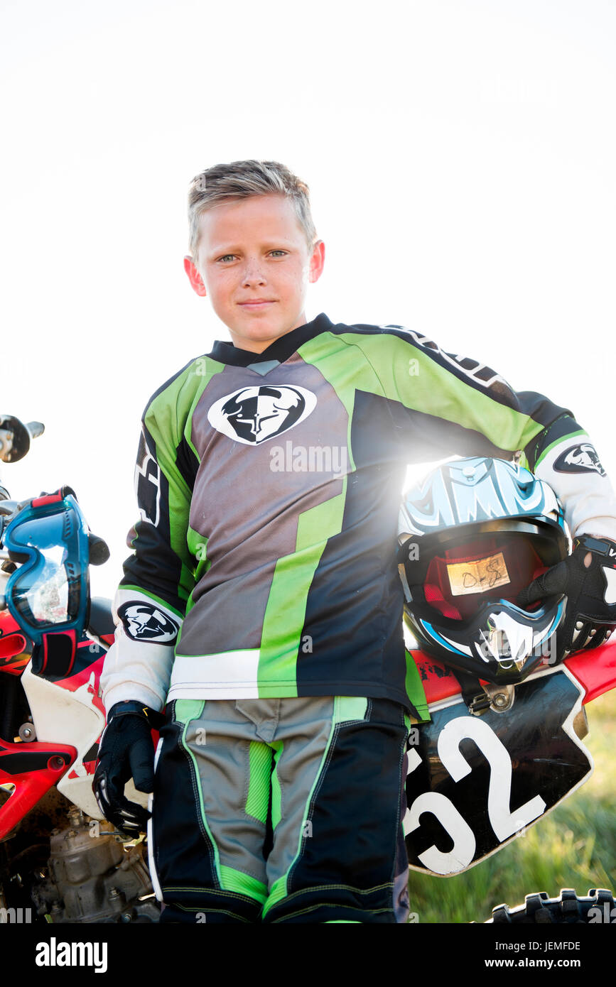 Boy holding motorcycle helmet Stock Photo - Alamy
