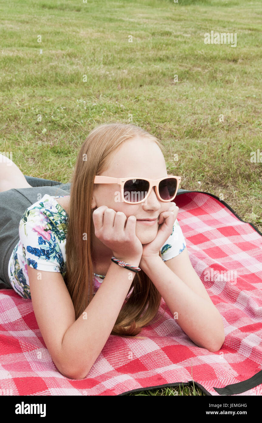 Girl sunglasses lying on blanket hires stock photography and images